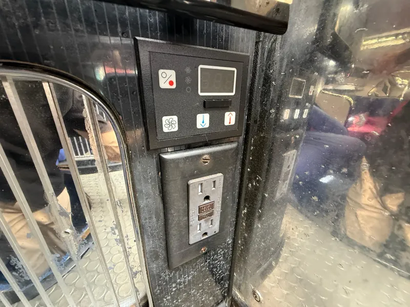 Slide: The Image of Control panel and outlet inside a 1988 Wellcraft Scarab 38 KV boat. - 40