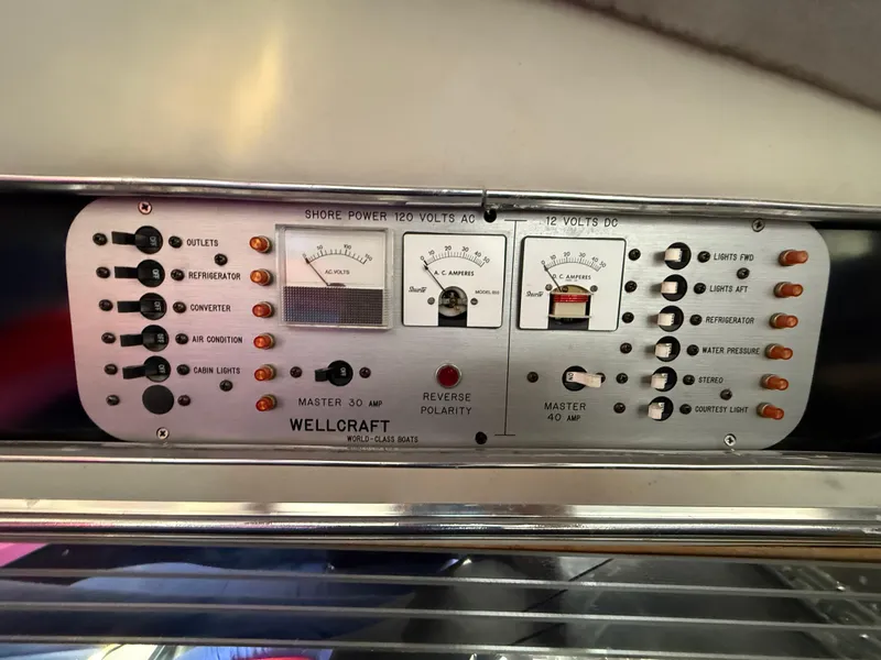 Slide: The Image of Control panel of a 1988 Wellcraft Scarab 38 KV boat, featuring various switches and meters. - 41
