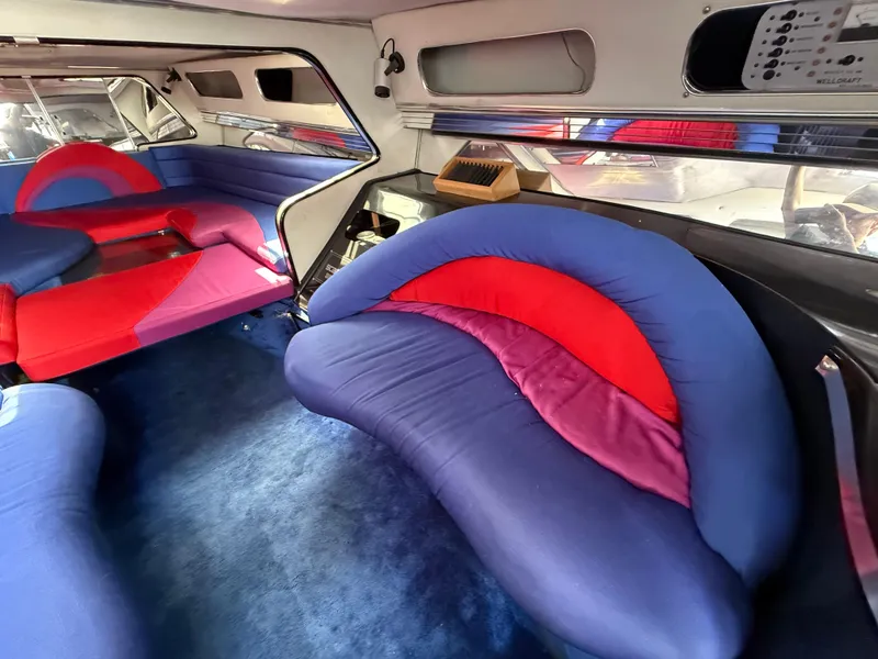 Slide: The Image of Interior of 1988 Wellcraft Scarab 38 KV with vibrant blue and red seating. - 44