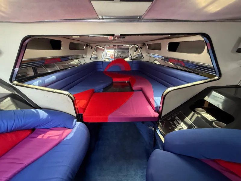 Slide: The Image of Interior of 1988 Wellcraft Scarab 38 KV with vibrant red and blue seating. - 45