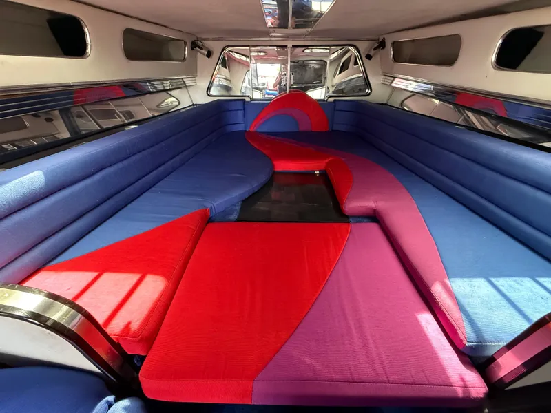 Slide: The Image of Interior of 1988 Wellcraft Scarab 38 KV with vibrant red and blue seating. - 46