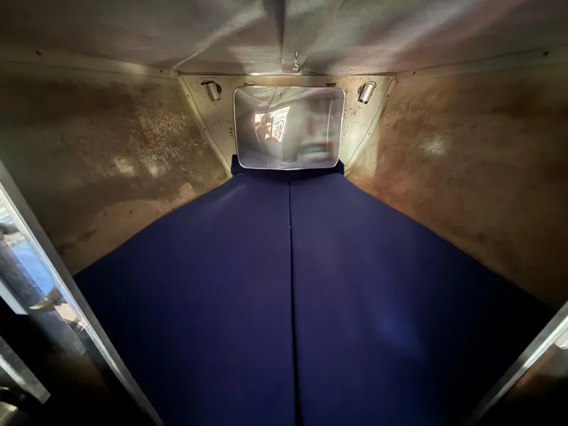 Slide: The Image of Interior cabin of 1988 Wellcraft Scarab 38 KV boat with blue bedding. - 49