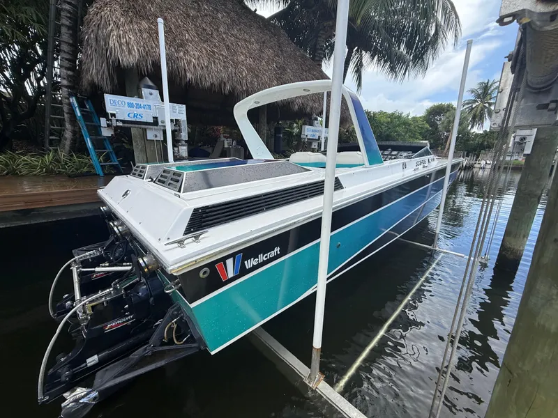 Slide: The Image of 1988 Wellcraft Scarab 38 KV boat docked, featuring sleek design and vibrant colors. - 6