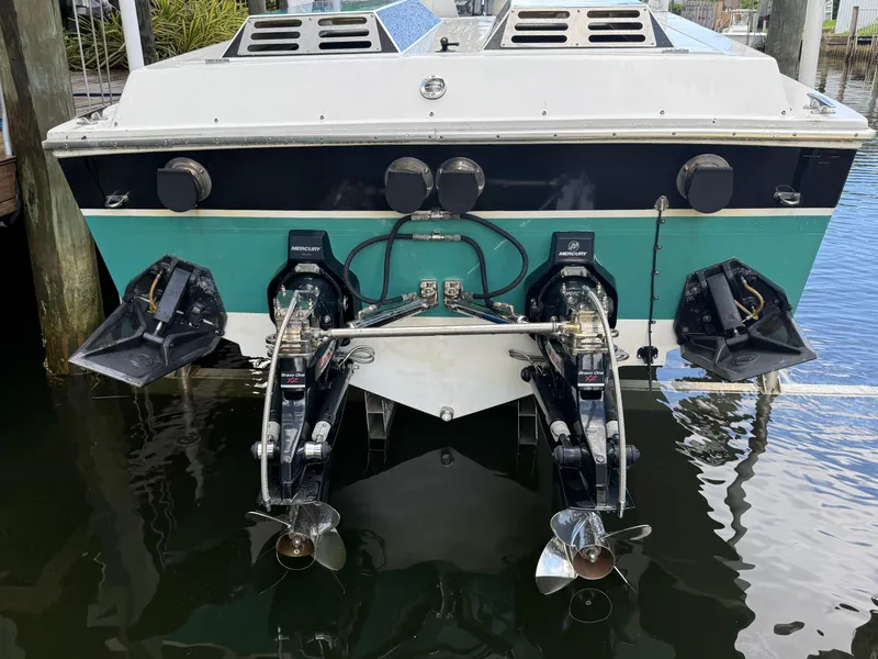 Slide: The Image of 1988 Wellcraft Scarab 38 KV boat with dual Mercury outboard engines in water. - 7