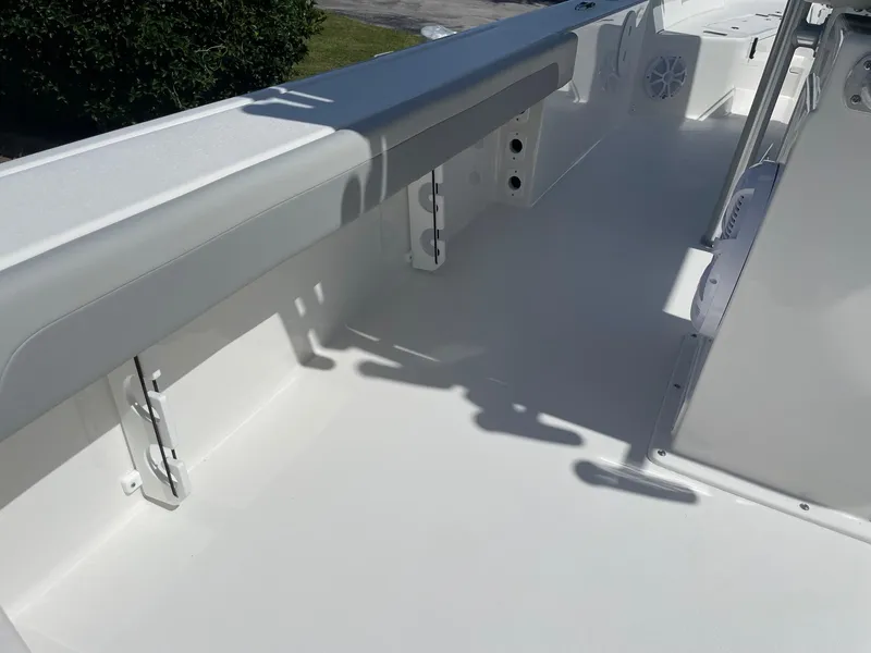 Slide: The Image of 2026 Bay Rider 269 Bay boat interior, featuring sleek white deck and seating area. - 16