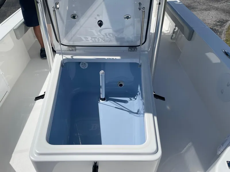 Slide: The Image of Open storage compartment on 2026 Bay Rider 269 Bay boat, featuring a blue interior. - 27