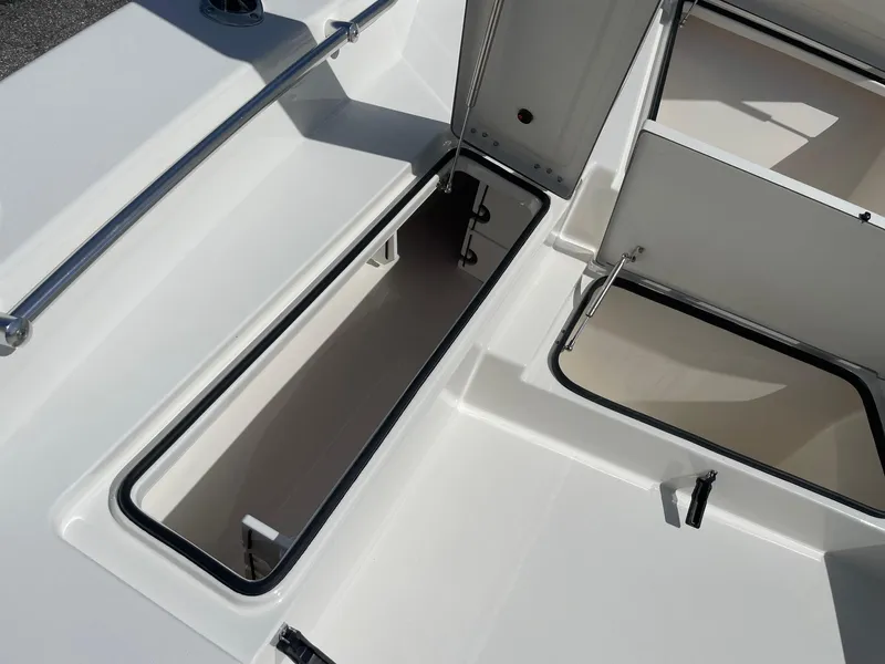 Slide: The Image of 2026 Bay Rider 269 Bay boat storage compartments with open hatches. - 33
