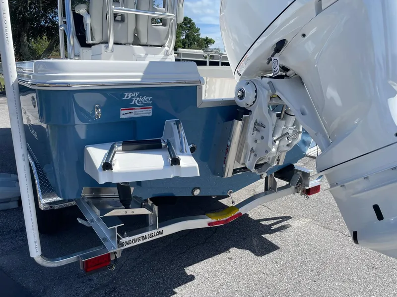 Slide: The Image of 2026 Bay Rider 269 Bay boat on trailer, rear view with motor and ladder. - 4