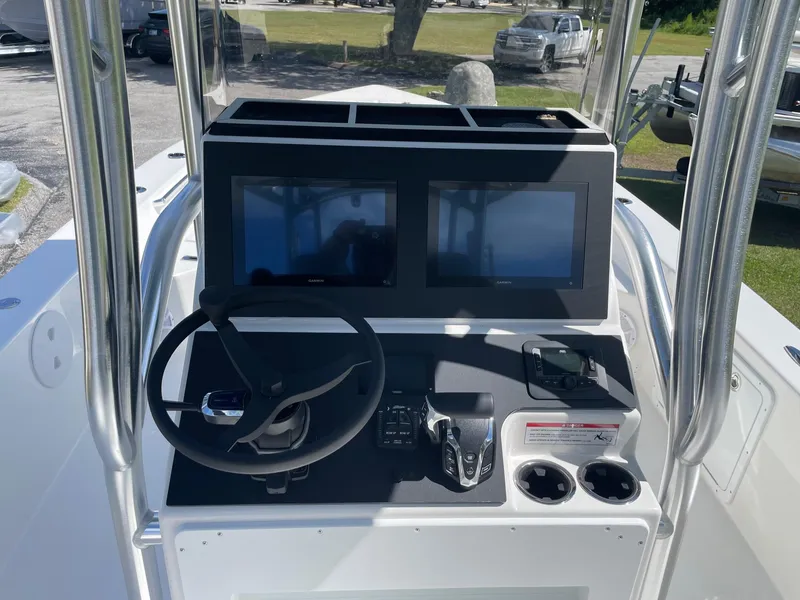 Slide: The Image of 2026 Bay Rider 269 Bay boat console with dual screens and steering wheel. - 18