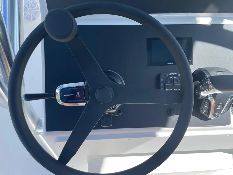 Slide: The Image of Steering wheel and controls of 2026 Bay Rider 269 Bay boat. - 21