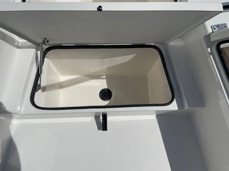 Slide: The Image of Open storage compartment on a 2026 Bay Rider 269 Bay boat. - 31