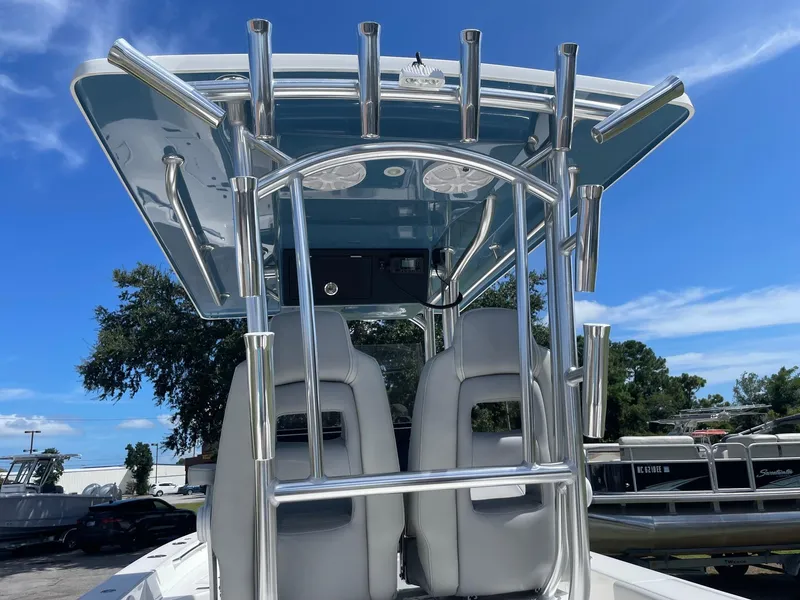 Slide: The Image of 2026 Bay Rider 269 Bay boat with T-top and dual seats under clear blue sky. - 5