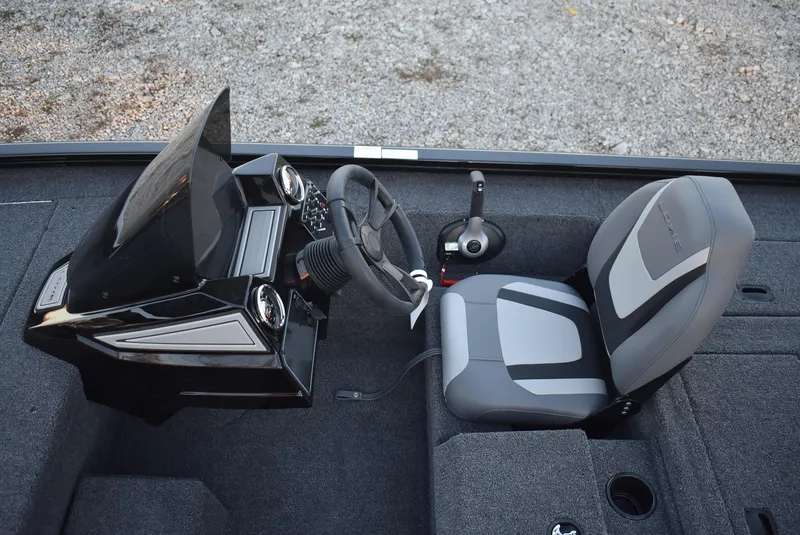Slide: The Image of 2025 Lowe Stinger 175 boat interior with steering console and seat, featuring modern design. - 11