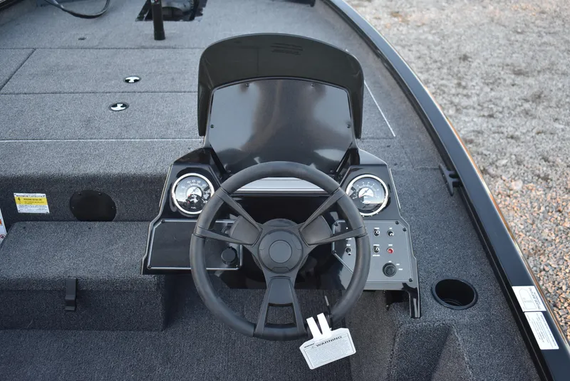 Slide: The Image of 2025 Lowe Stinger 175 boat dashboard with steering wheel and gauges. - 12