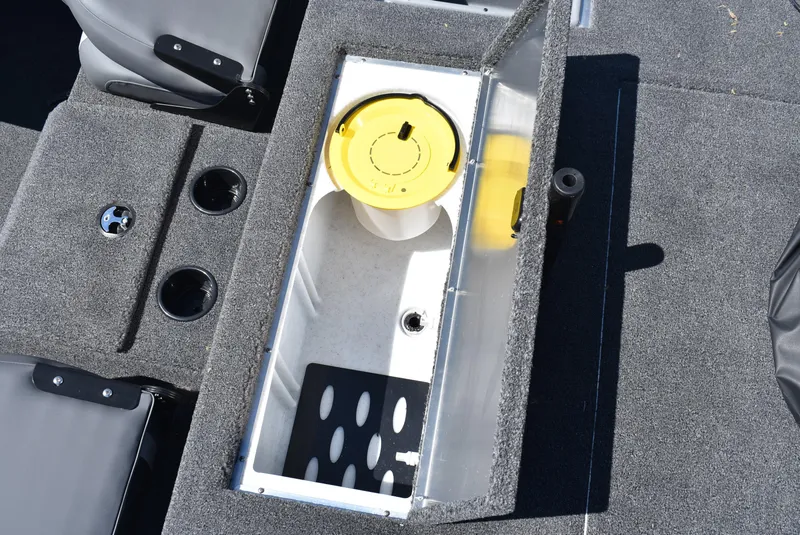 Slide: The Image of 2025 Lowe Stinger 175 boat interior with storage compartment and cup holders. - 15
