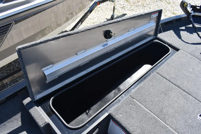 Slide: The Image of Open storage compartment on 2025 Lowe Stinger 175 boat, showcasing interior space. - 18