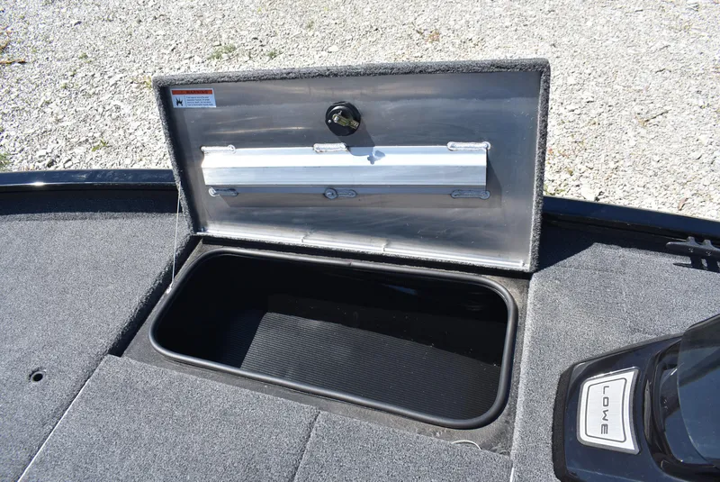 Slide: The Image of Open storage compartment on 2025 Lowe Stinger 175 boat, showing interior details. - 19