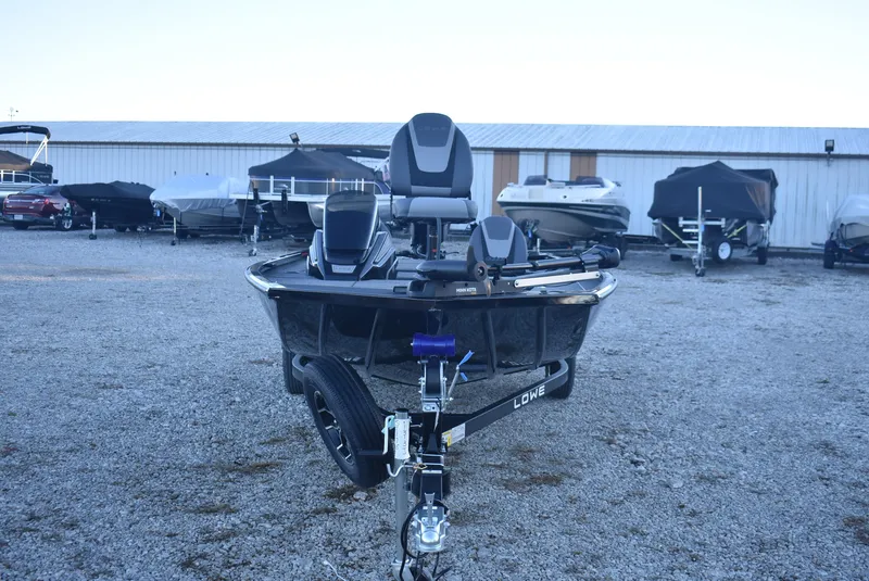 Slide: The Image of 2025 Lowe Stinger 175 boat on trailer in outdoor storage area. - 3