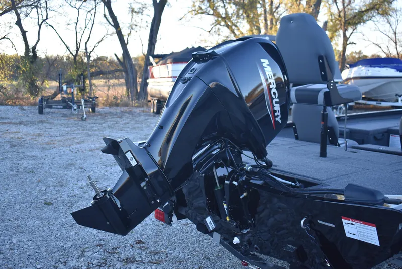 Slide: The Image of 2025 Lowe Stinger 175 boat with Mercury outboard motor in a gravel lot. - 7