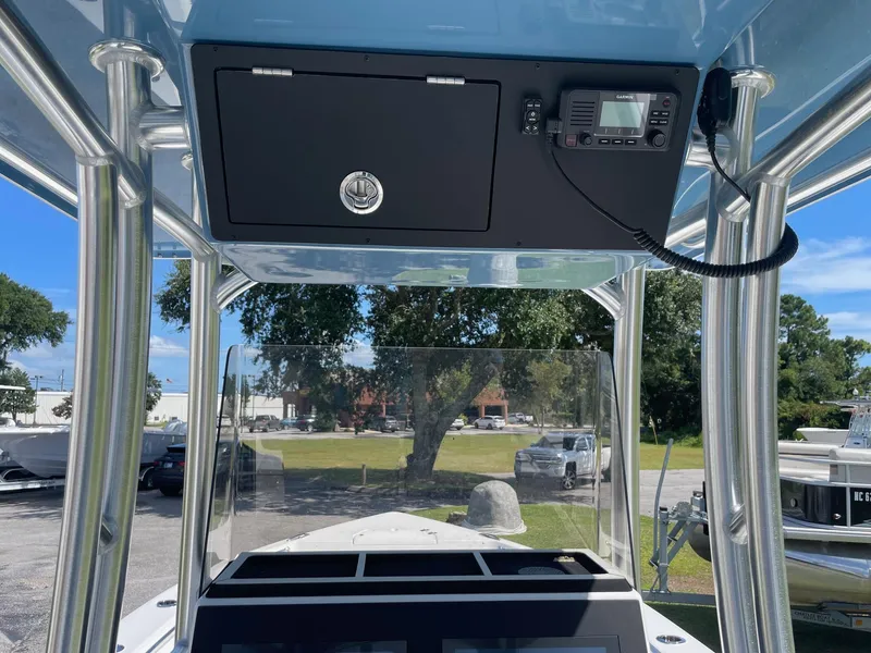 Slide: The Image of 2026 Bay Rider 269 Bay boat console with radio and storage compartment. - 19
