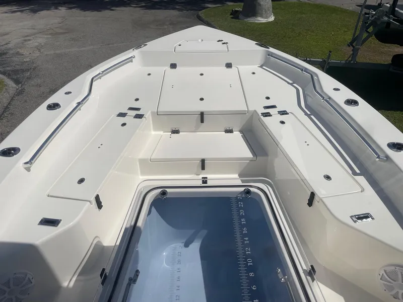 Slide: The Image of 2026 Bay Rider 269 Bay boat deck with storage compartments and sleek design. - 25