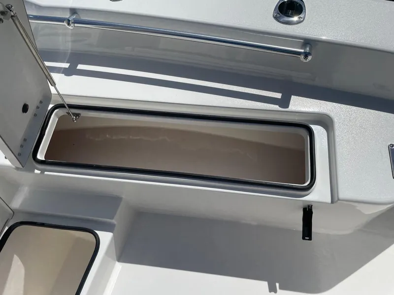 Slide: The Image of Open storage compartment on 2026 Bay Rider 269 Bay boat deck. - 32