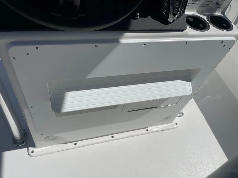 Slide: The Image of Bay Rider 269 Bay 2026 boat console with cup holders and storage compartment. - 35