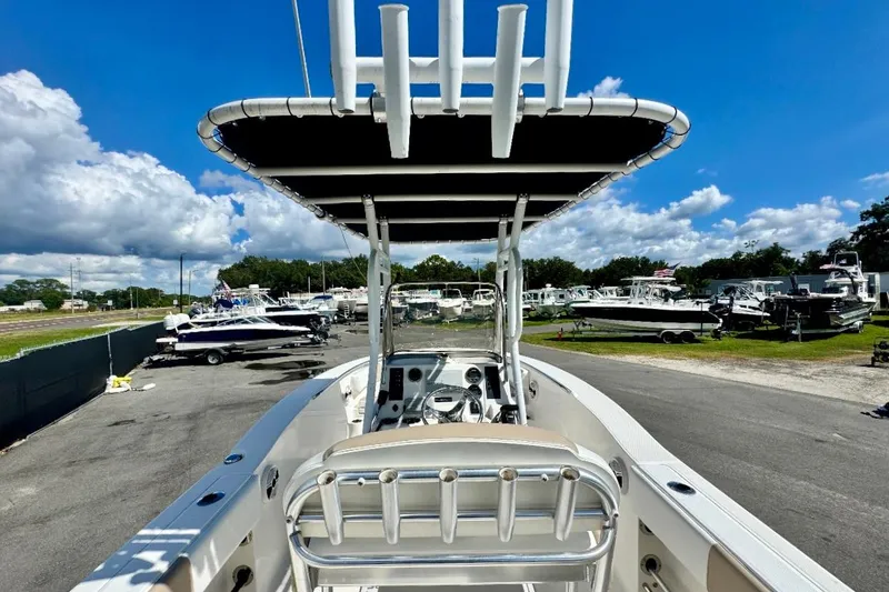 Slide: The Image of 2017 Robalo R200 Center Console boat in a marina under a clear blue sky. - 15