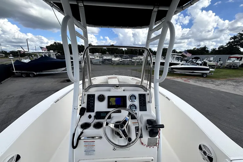 Slide: The Image of 2017 Robalo R200 Center Console boat interior with steering wheel and navigation controls. - 17
