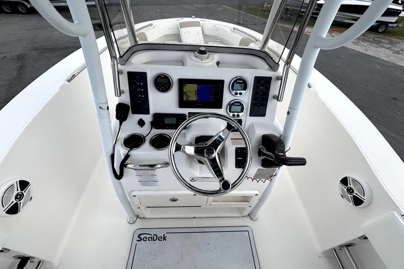 Slide: The Image of 2017 Robalo R200 Center Console boat dashboard with steering wheel and navigation controls. - 18
