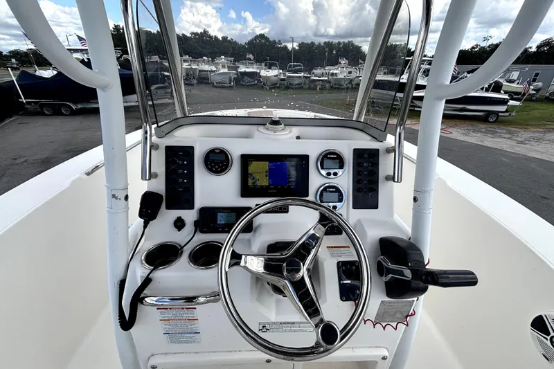 Slide: The Image of 2017 Robalo R200 Center Console boat dashboard with steering wheel and navigation controls. - 19