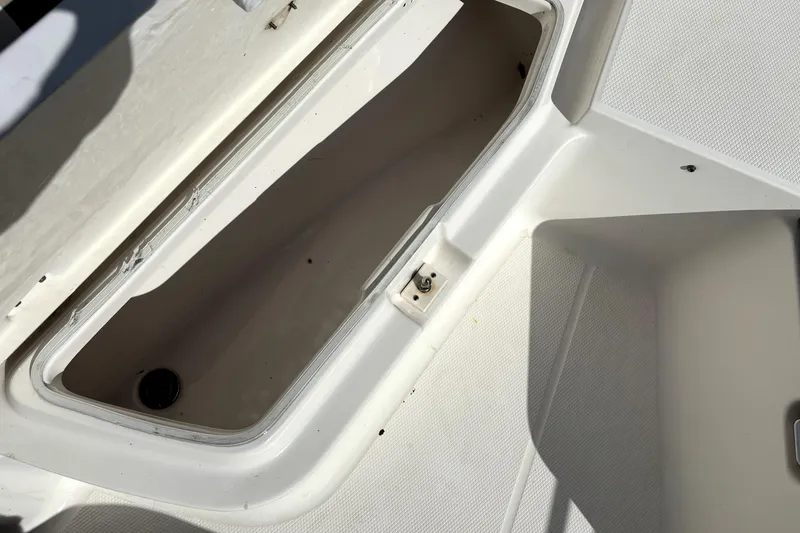 Slide: The Image of 2017 Robalo R200 Center Console storage compartment, open and empty. - 25