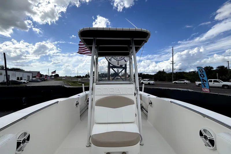 Slide: The Image of 2017 Robalo R200 Center Console boat with American flag, under a partly cloudy sky. - 30