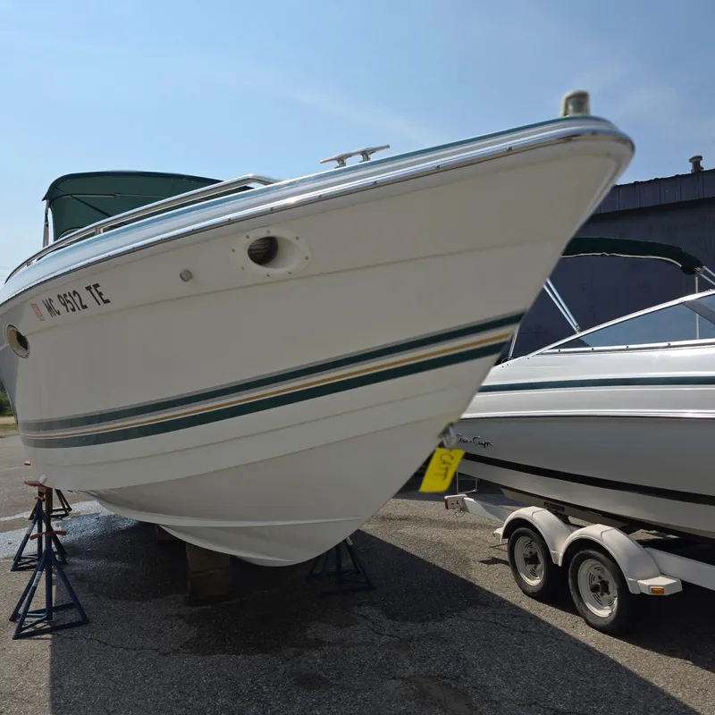 Slide: The Image of 1998 Formula 33 Super Sun Sport boat on stands, parked outdoors. - 10