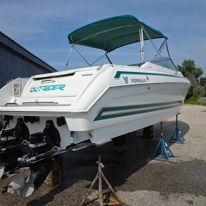 Slide: The Image of 1998 Formula 33 Super Sun Sport boat on stands, featuring a green canopy. - 11