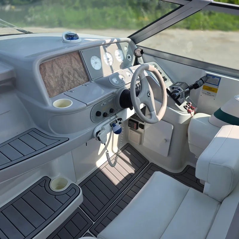 Slide: The Image of 1998 Formula 33 Super Sun Sport boat interior with steering wheel and control panel. - 17