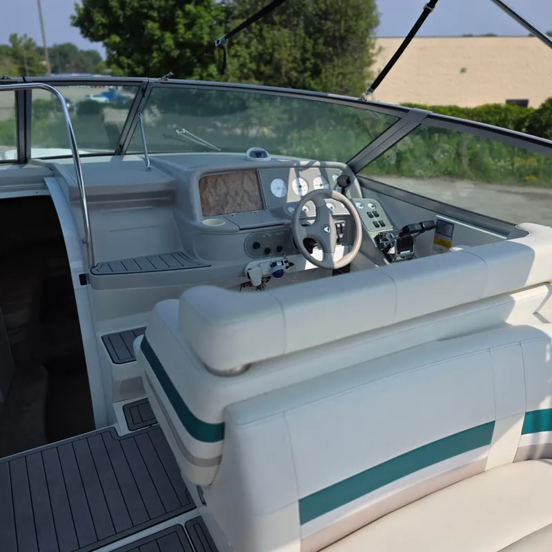 Slide: The Image of 1998 Formula 33 Super Sun Sport boat interior with steering wheel and dashboard. - 18