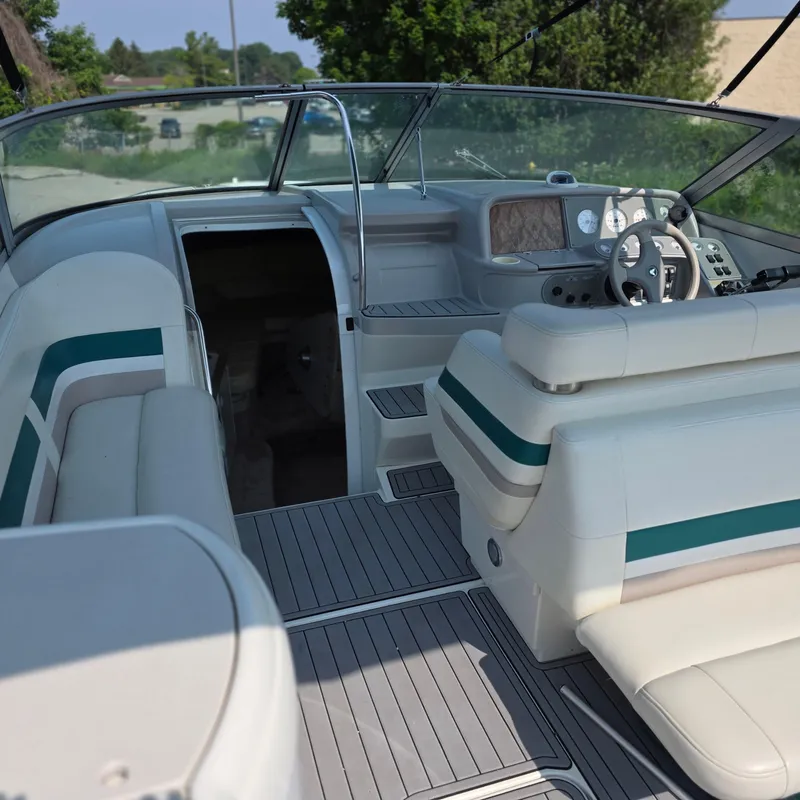 Slide: The Image of 1998 Formula 33 Super Sun Sport boat interior with white seating and steering wheel. - 19