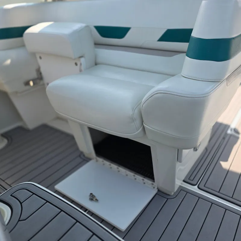 Slide: The Image of 1998 Formula 33 Super Sun Sport boat interior with white seating and storage compartment. - 20