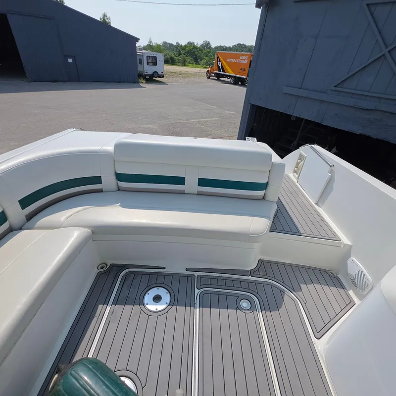 Slide: The Image of 1998 Formula 33 Super Sun Sport boat interior with white seating and gray deck. - 21