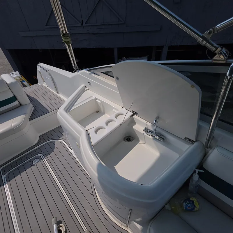 Slide: The Image of 1998 Formula 33 Super Sun Sport boat interior with sink and seating area. - 22
