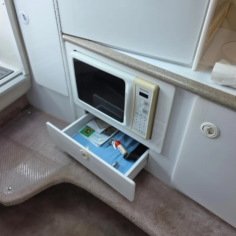Slide: The Image of Interior of a 1998 Formula 33 Super Sun Sport with microwave and open drawer. - 28