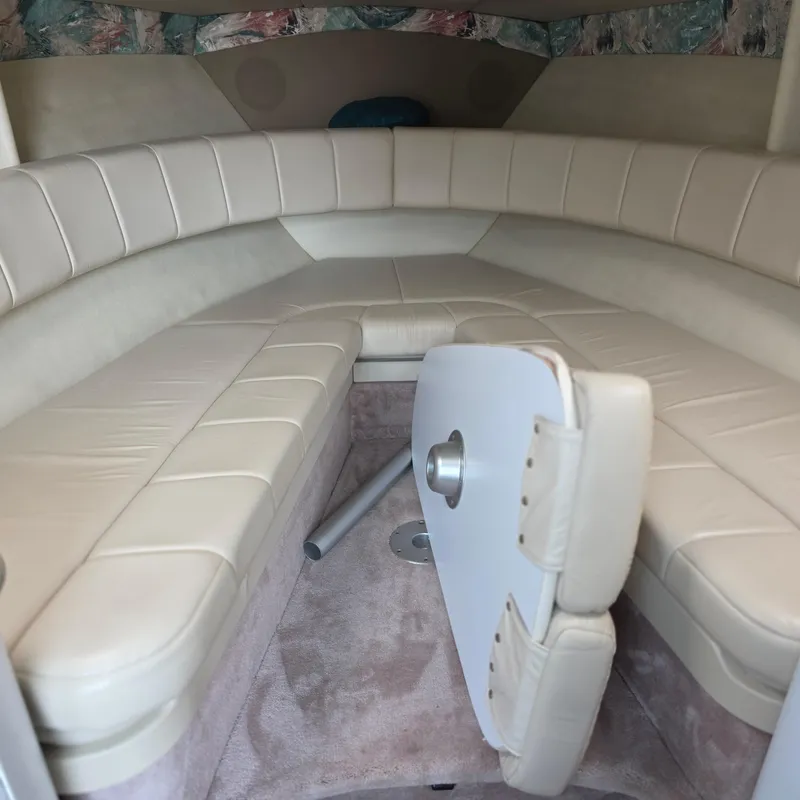 Slide: The Image of 1998 Formula 33 Super Sun Sport cabin interior with beige seating and foldable table. - 31