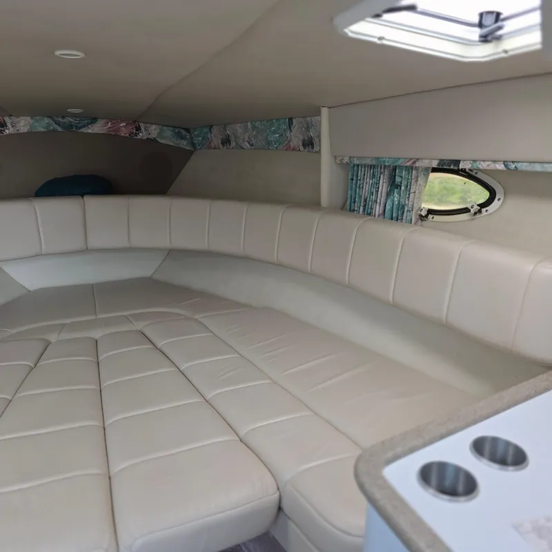 Slide: The Image of Interior of 1998 Formula 33 Super Sun Sport boat with beige seating and small window. - 32