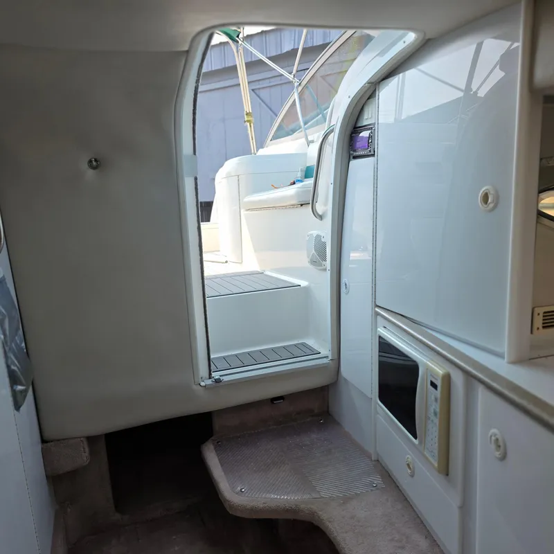 Slide: The Image of Interior view of a 1998 Formula 33 Super Sun Sport boat, featuring a compact cabin space. - 33