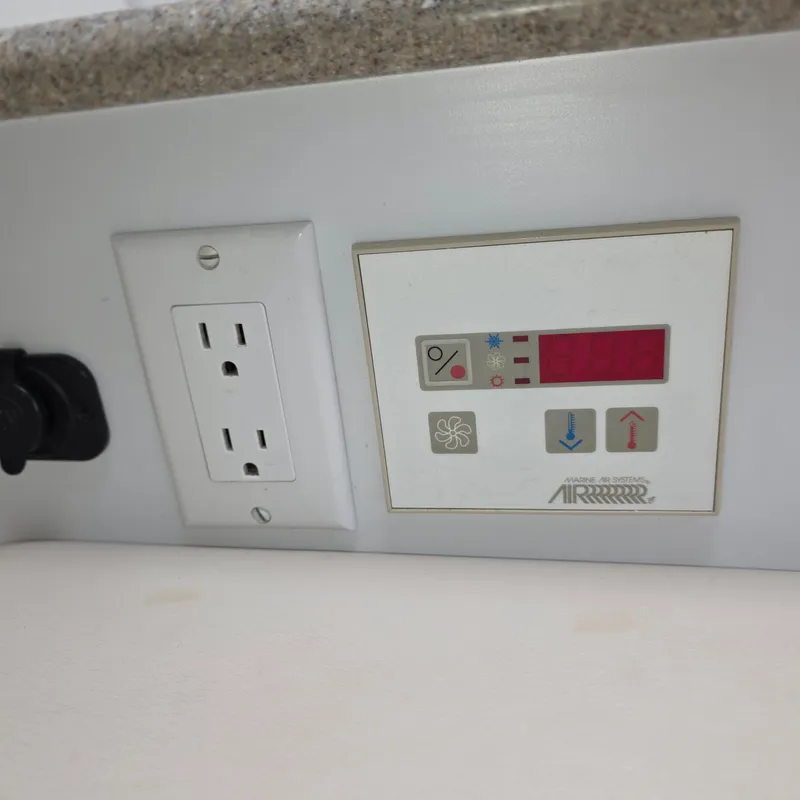 Slide: The Image of Control panel and outlet on 1998 Formula 33 Super Sun Sport boat. - 36