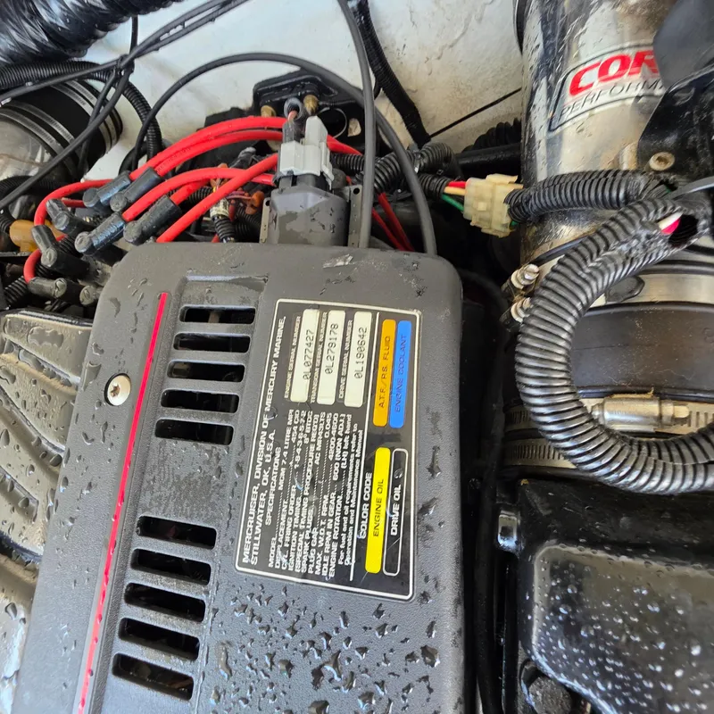 Slide: The Image of Close-up of a 1998 Formula 33 Super Sun Sport engine with visible wiring and labels. - 44