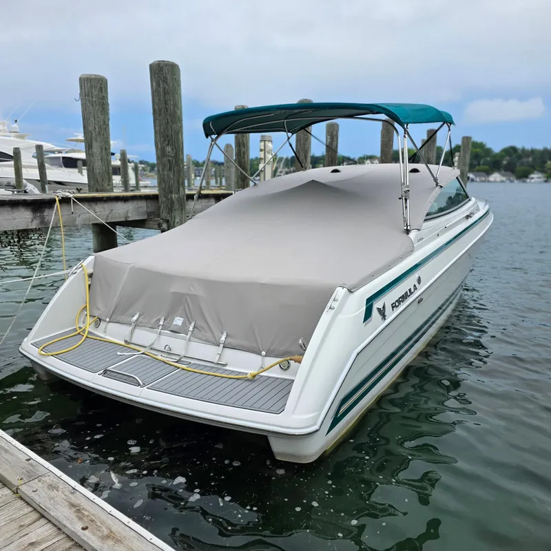Slide: The Image of 1998 Formula 33 Super Sun Sport boat docked with cover and canopy. - 6
