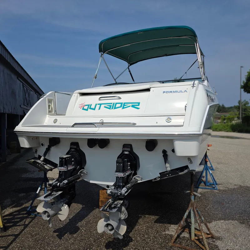 Slide: The Image of 1998 Formula 33 Super Sun Sport boat with dual outboard motors on stands. - 7