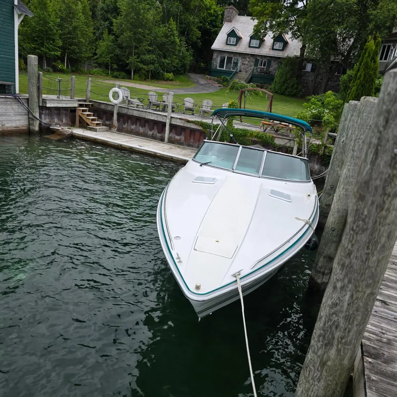 Slide: The Image of 1998 Formula 33 Super Sun Sport boat docked by a lakeside house. - 9